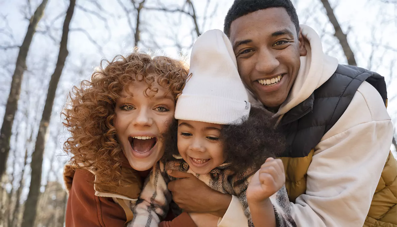 Beautiful family photo featuring mother, father, and child, capturing a loving and joyful moment - banner