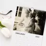 Personalised photo calendar for June 2022 featuring a family walking down a tree-lined path. The calendar is placed on a white desk alongside a cup of tea, a pencil, a pair of glasses, and a laptop. Ideal for gifts for men, Christmas gift ideas, and personalised gifts in South Africa.