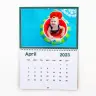 Personalised wall calendar for April 2023 featuring a colourful image of a smiling child in a pool float. The calendar has a clean, minimalist design with dates clearly marked. Ideal for gifts such as baby shower gift ideas, Christmas gifts, or personalised gifts in South Africa.