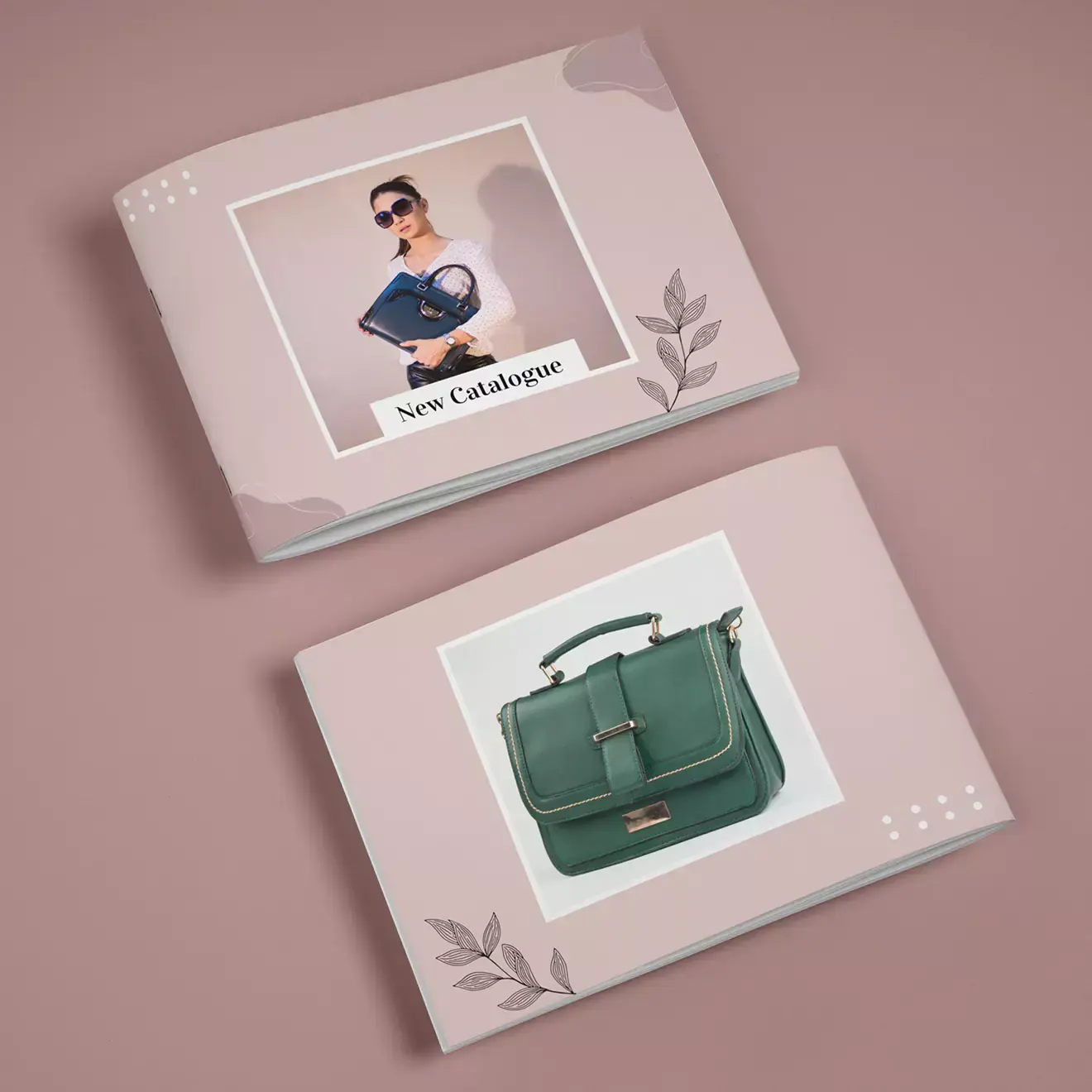 Two stylish photo books with soft pink covers featuring elegant leaf designs. The top book showcases a woman holding a handbag with the text ''New Catalogue,'' while the bottom book displays a green handbag. Ideal for personalised gifts in South Africa, photo albums, and Christmas gift ideas.